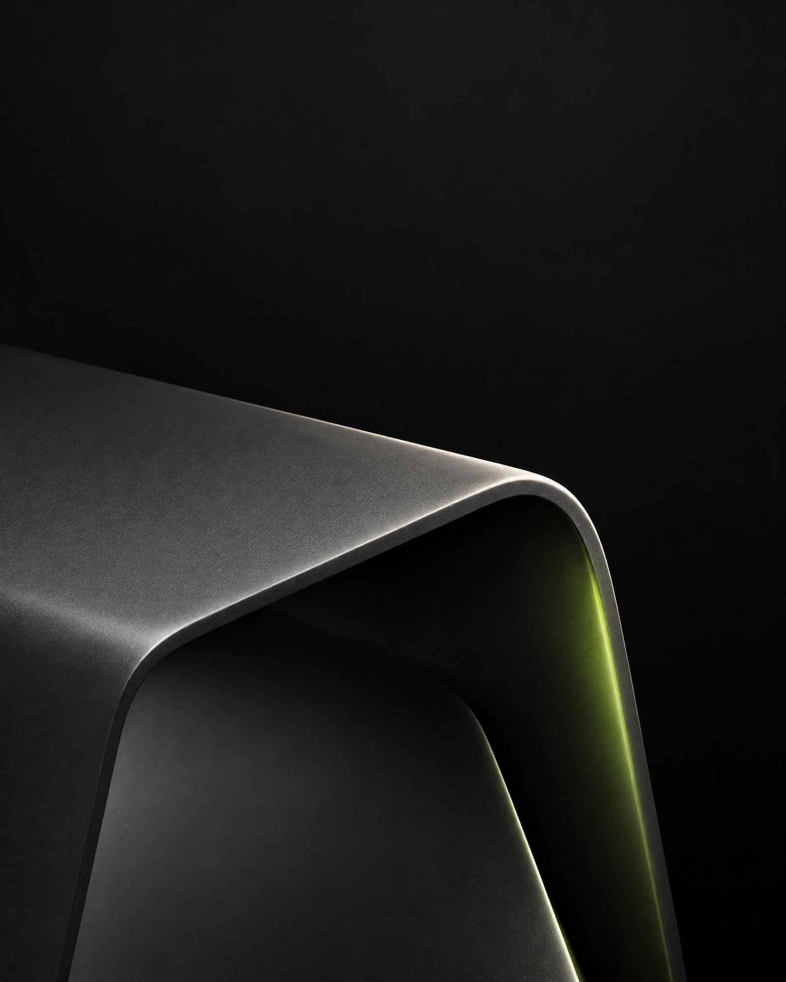 Matte graphite product form outlined by soft ivory light and a subtle lime reflected edge against a dark studio background.