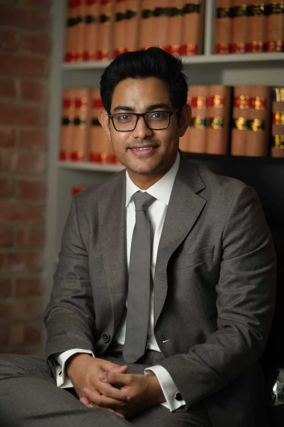 Barrister Tahmidur Rahman seated in a professional library setting