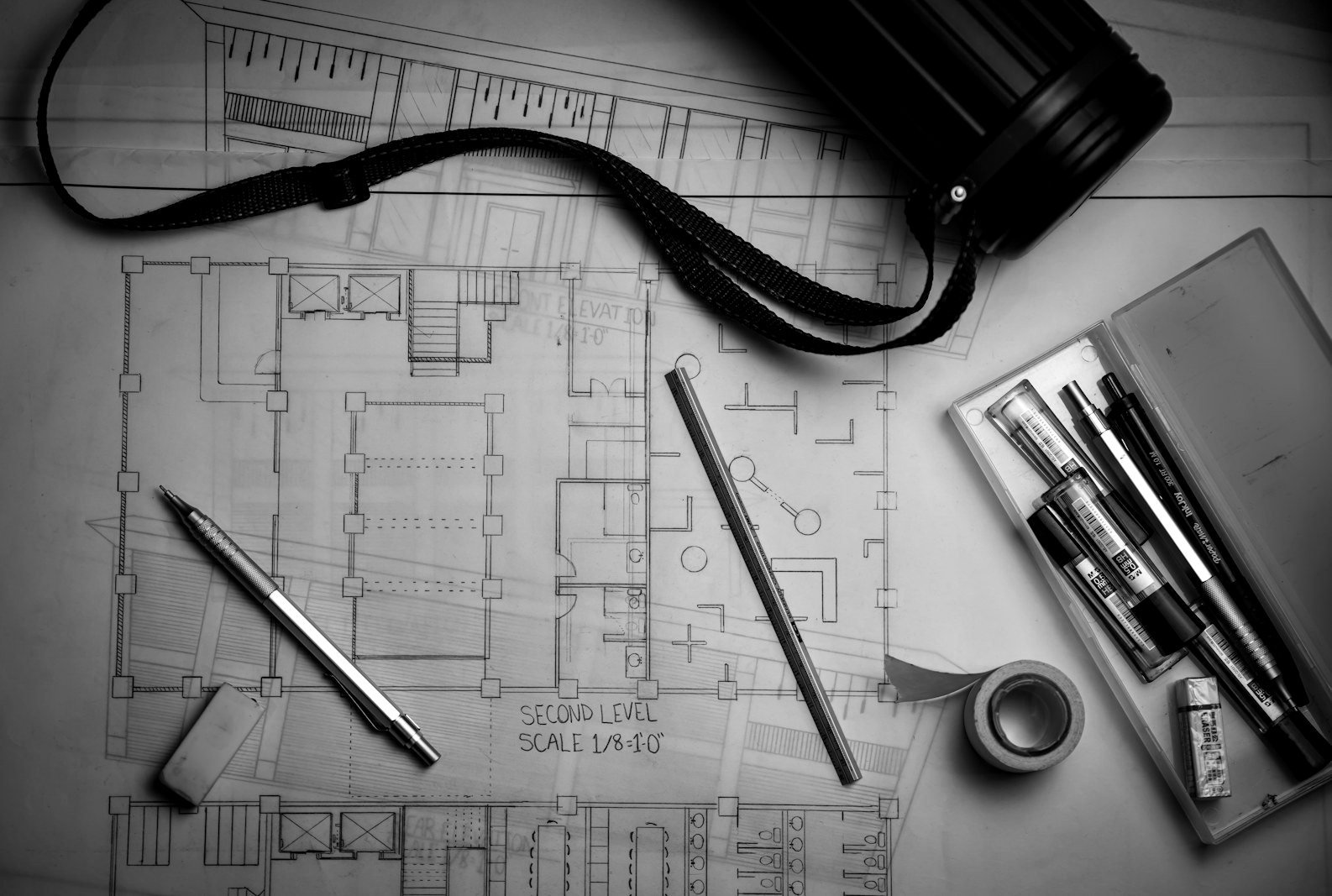 Buying apartment Dhaka — architect's approved building drawings and plans on a desk
