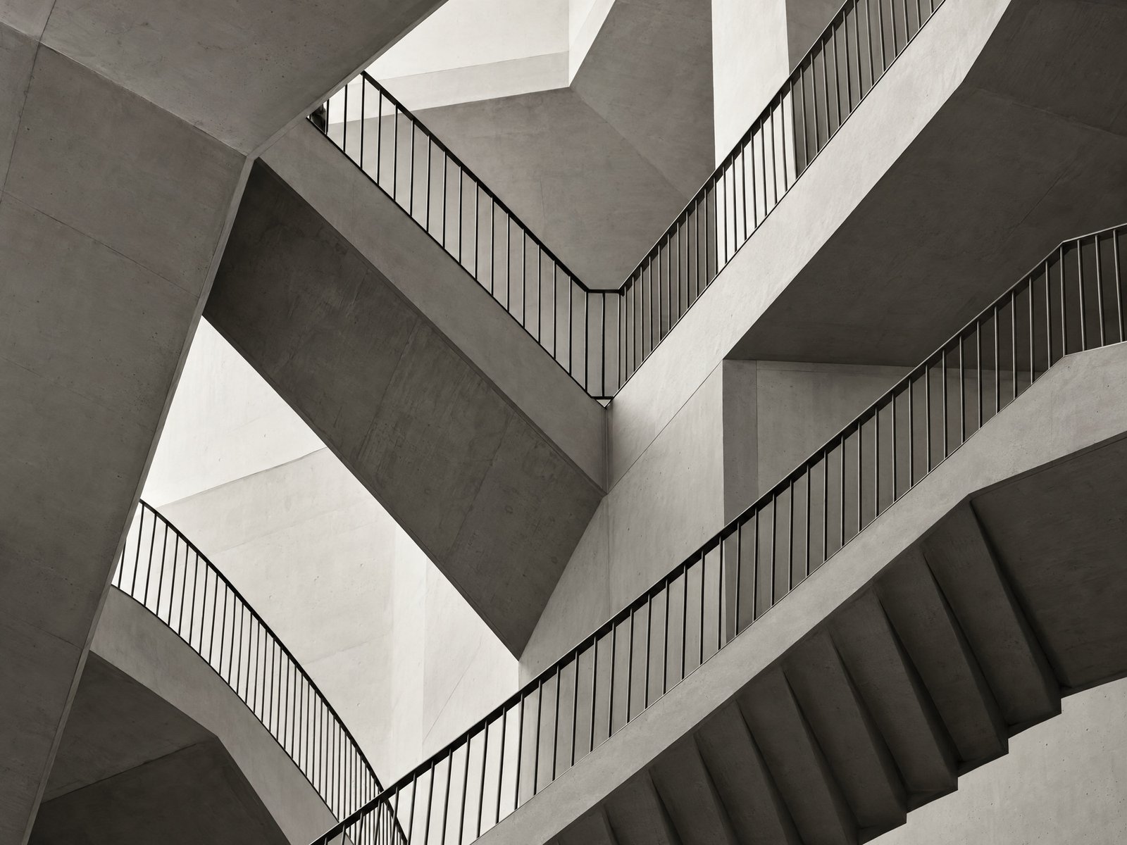 Black-and-white intersecting staircases representing layers of governance and oversight.