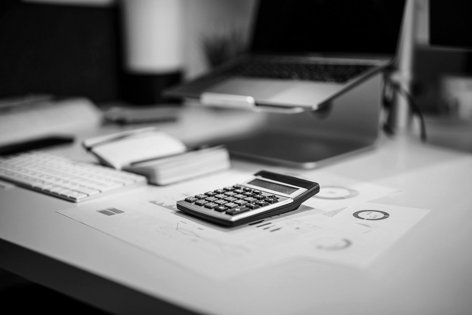 Cost of arbitration in Bangladesh — calculator and legal fee invoices on a lawyer's desk
