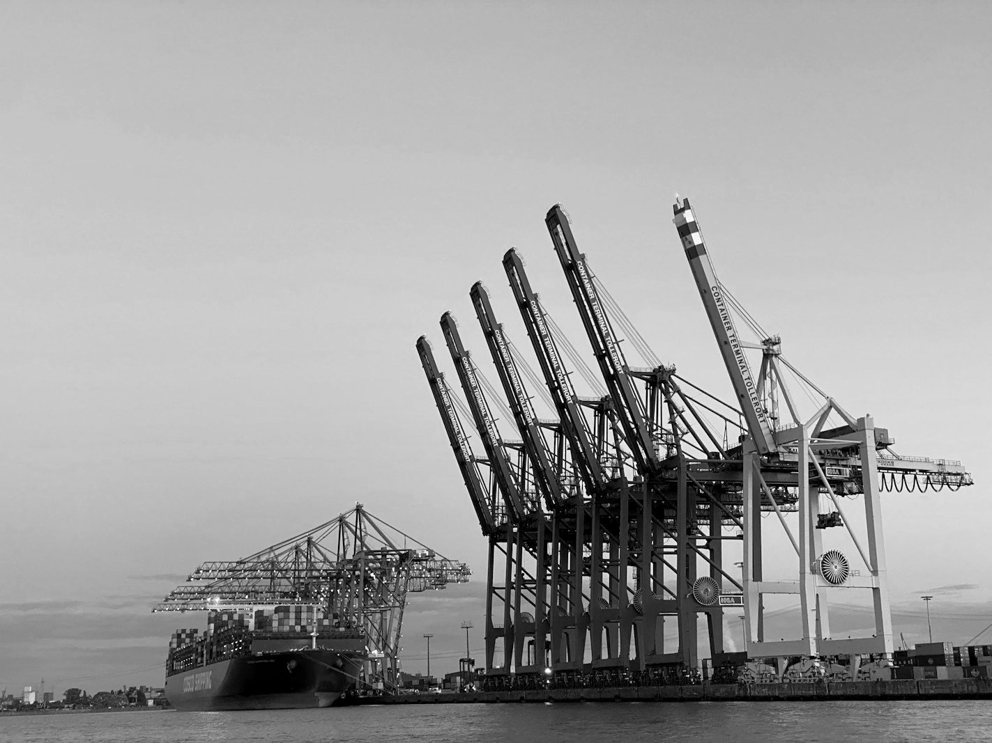 HS code dispute Bangladesh — shipping containers stacked at a port awaiting customs assessment