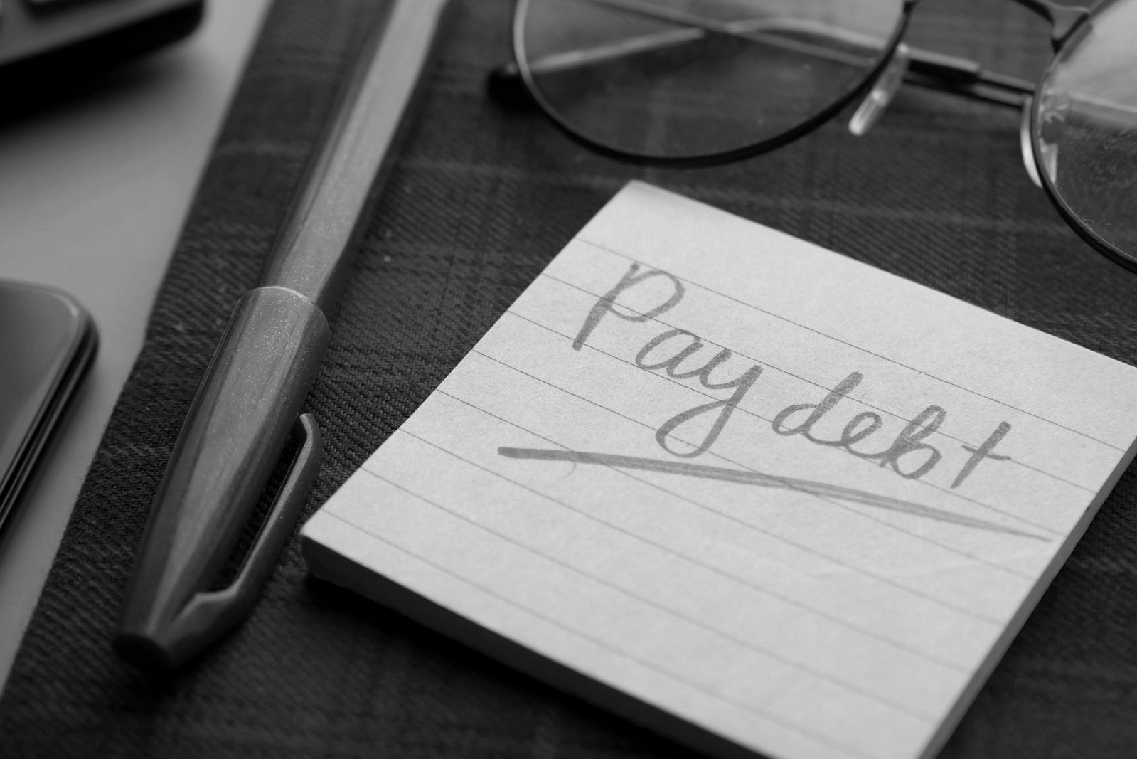 Loan defaulter Bangladesh — borrower reviewing a bank loan statement and default notice