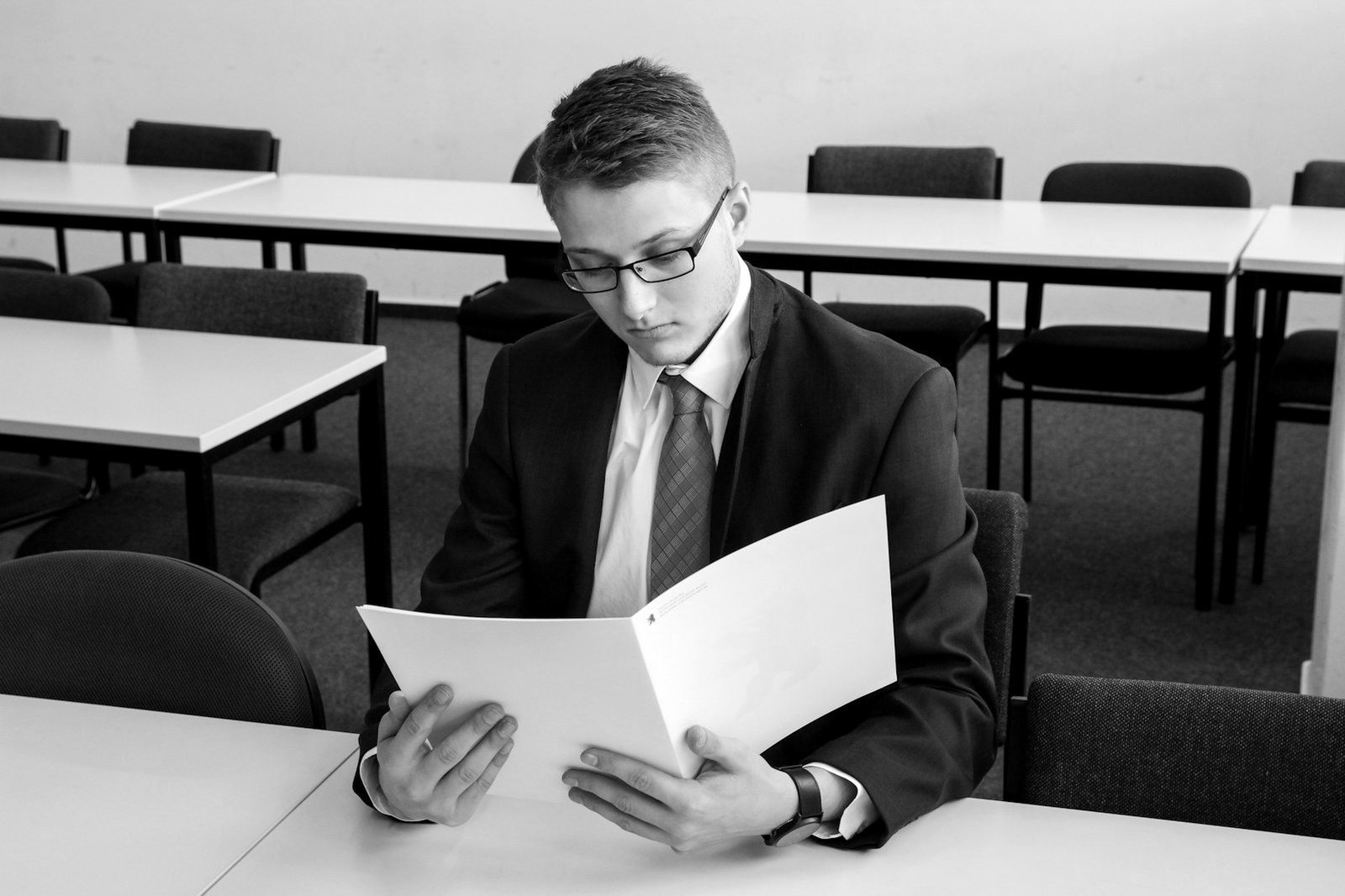 Local government suspension writ preparation — lawyer reviewing meeting minutes and attendance records