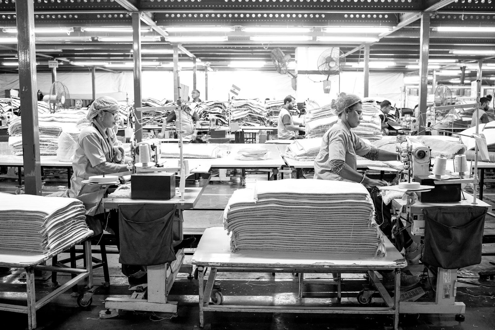 Minimum wage Bangladesh — garment workers at sewing machines on a factory floor