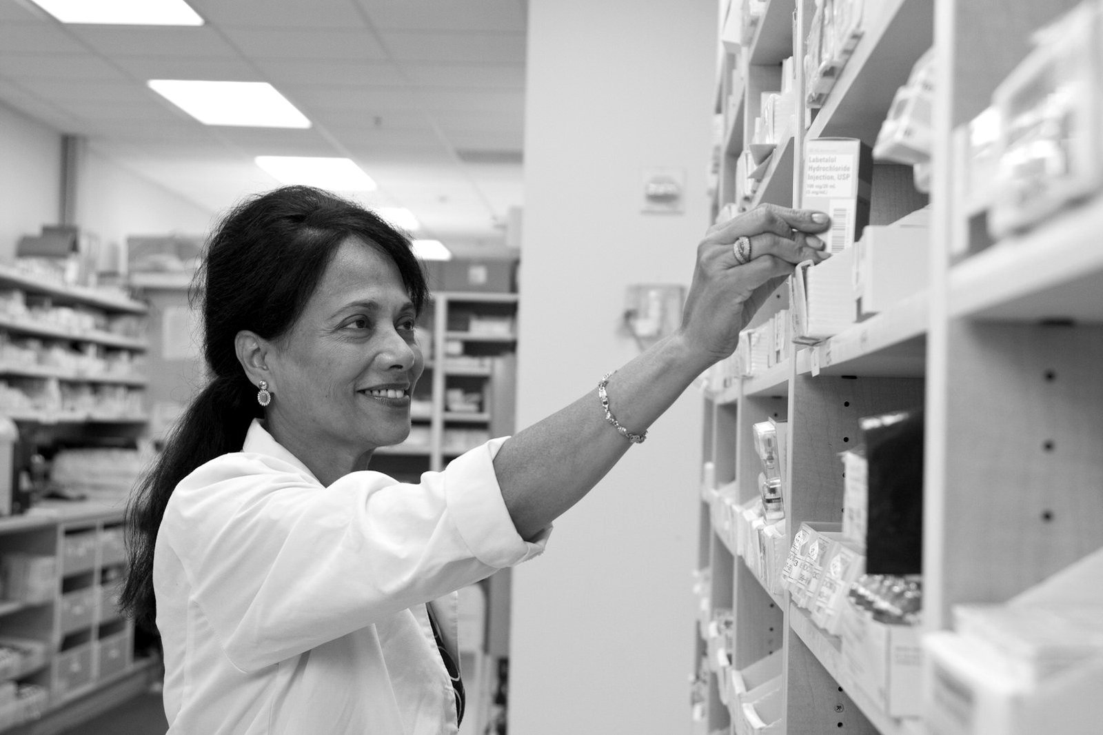 Service business registration Bangladesh — pharmacist at a retail pharmacy counter