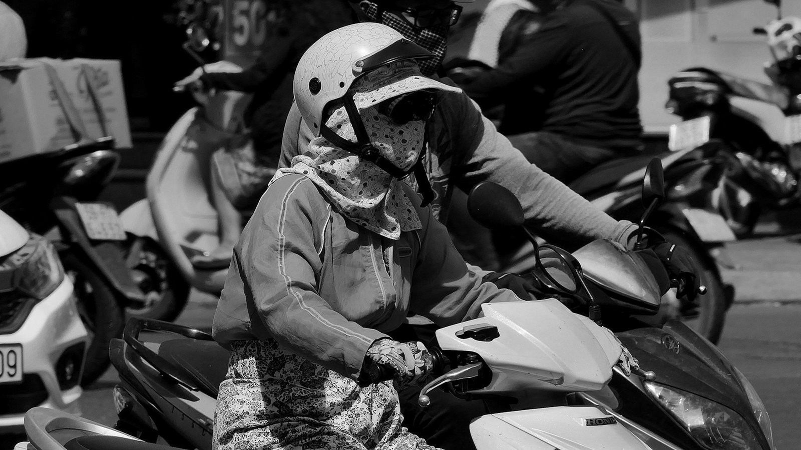 Traffic laws Bangladesh — motorcycle riders wearing helmets in city traffic
