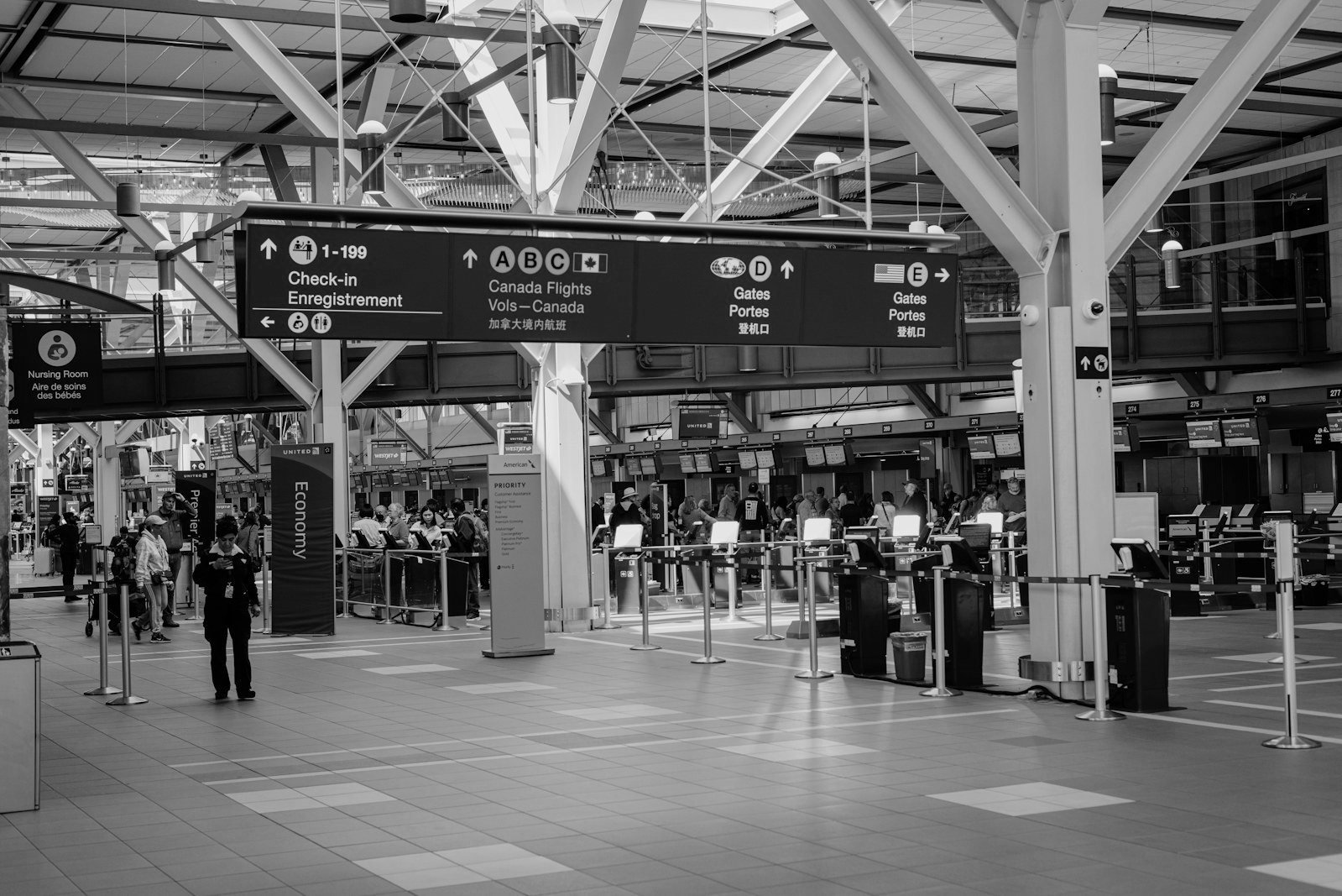 US immigration forms and fees — traveller at an airport departure gate considering advance parole